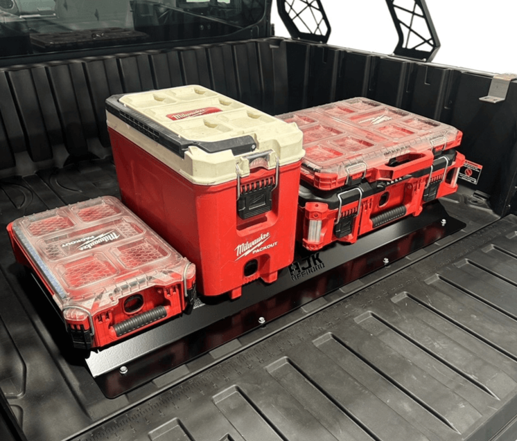 The image shows the rear packout mount installed in the bed of a Polaris Ranger 1500XD UTV, with multiple red and gray Milwaukee tool boxes placed on top.